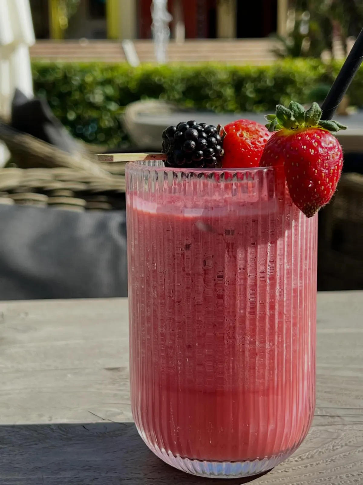 A berry smoothie topped with fresh fruit
