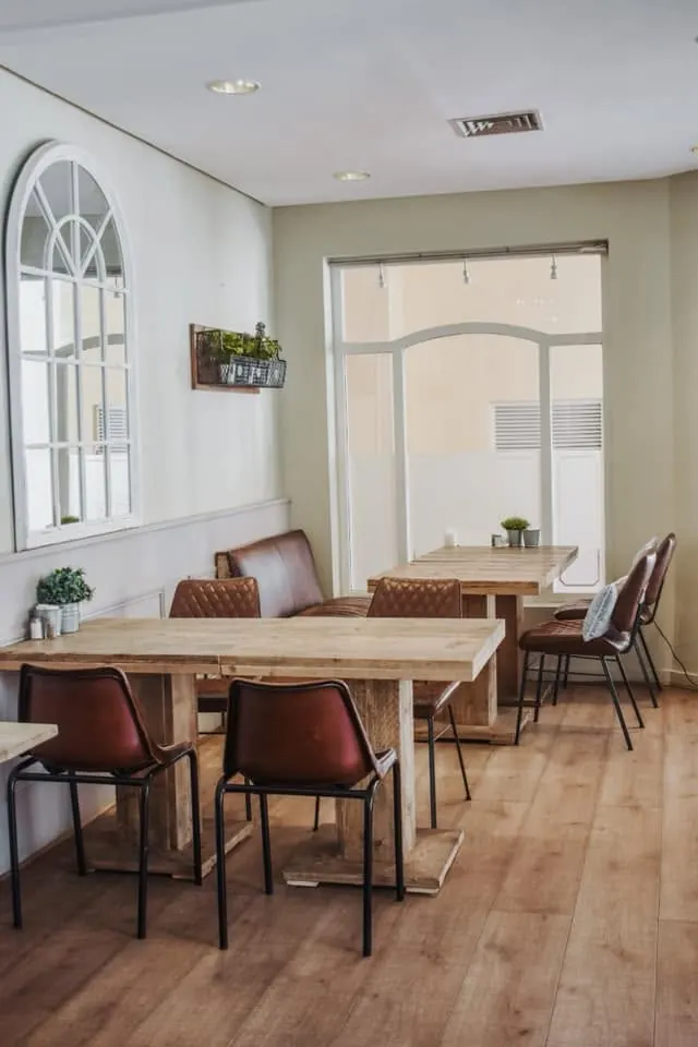 The Bistro dining room with wooden floors and arched window