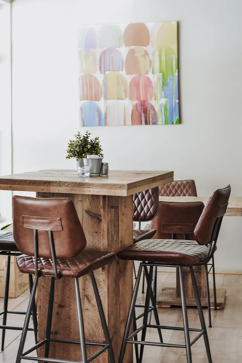 High tables and leather stools in The Bistro