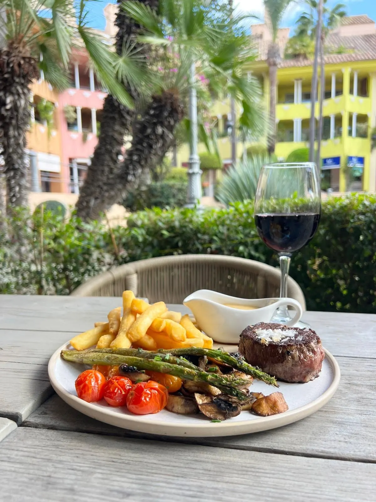 Fillet steak with chips and a glass of red wine on the terrace