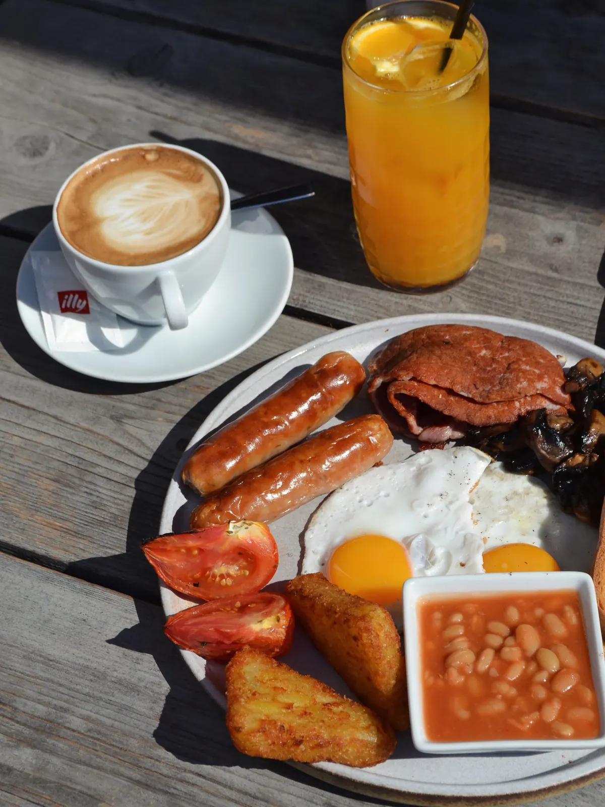 A full English breakfast with cappuccino and fresh orange juice