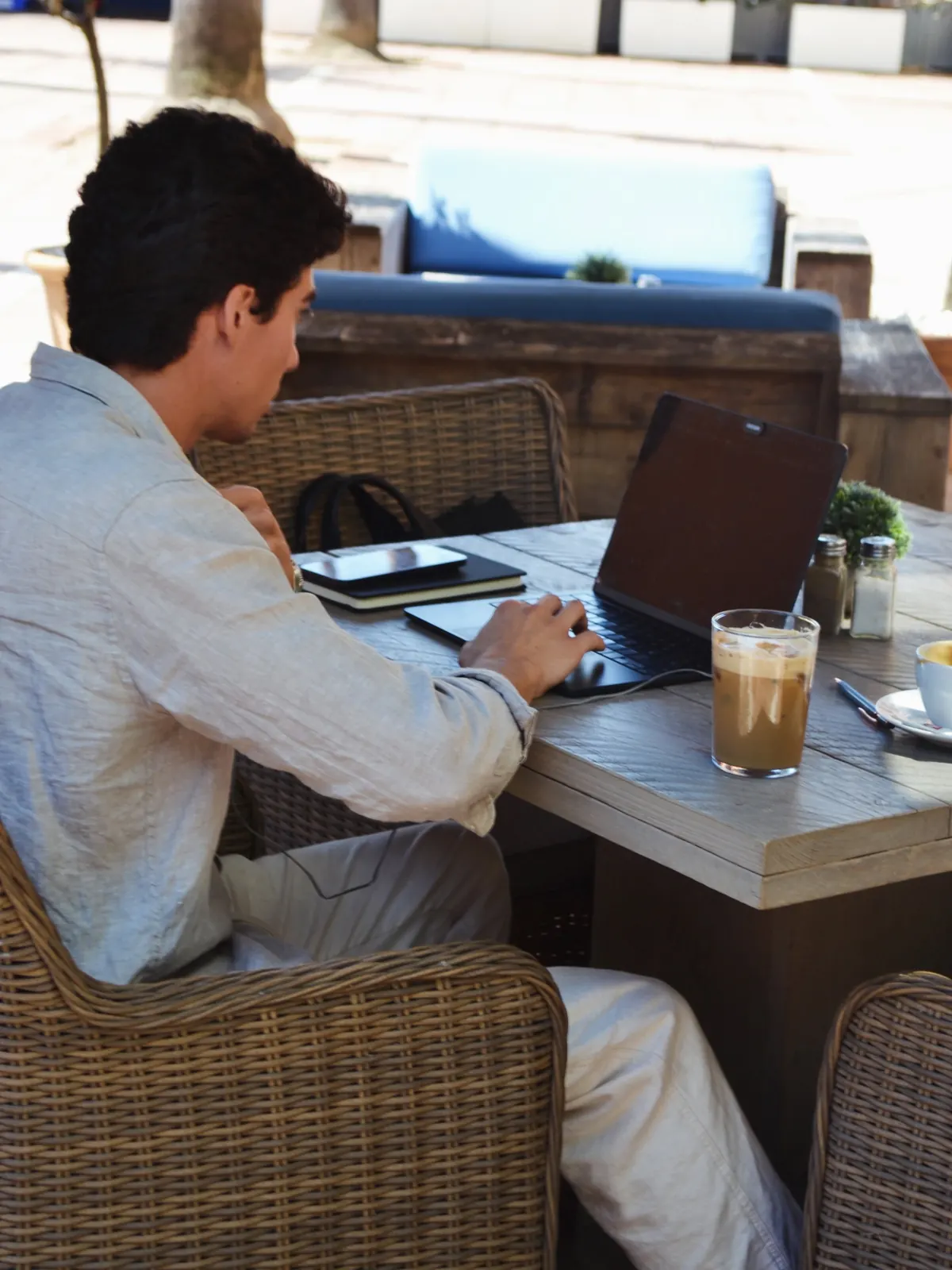 A guest working over coffee on the terrace