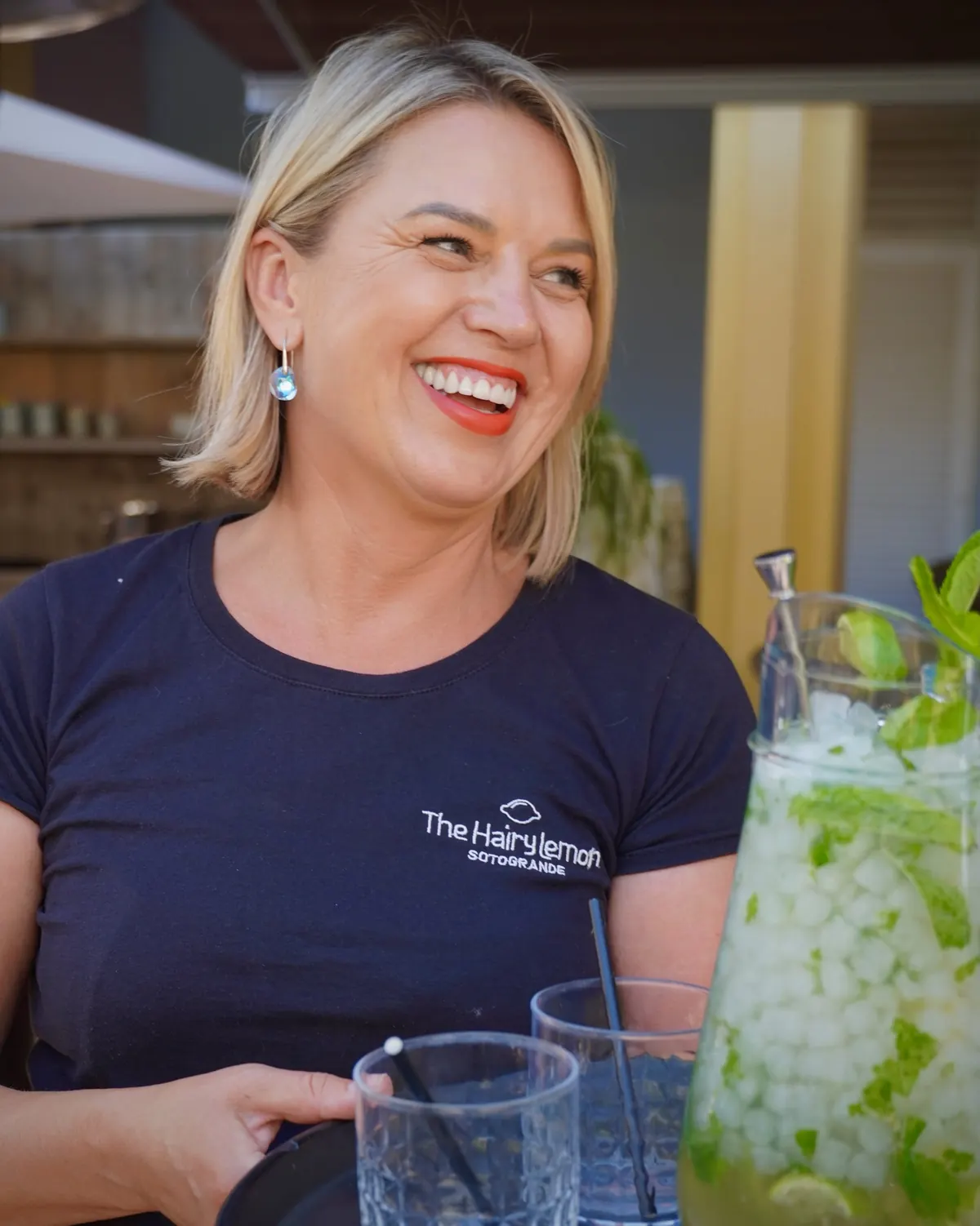 Brigita, part of the management team, behind the bar